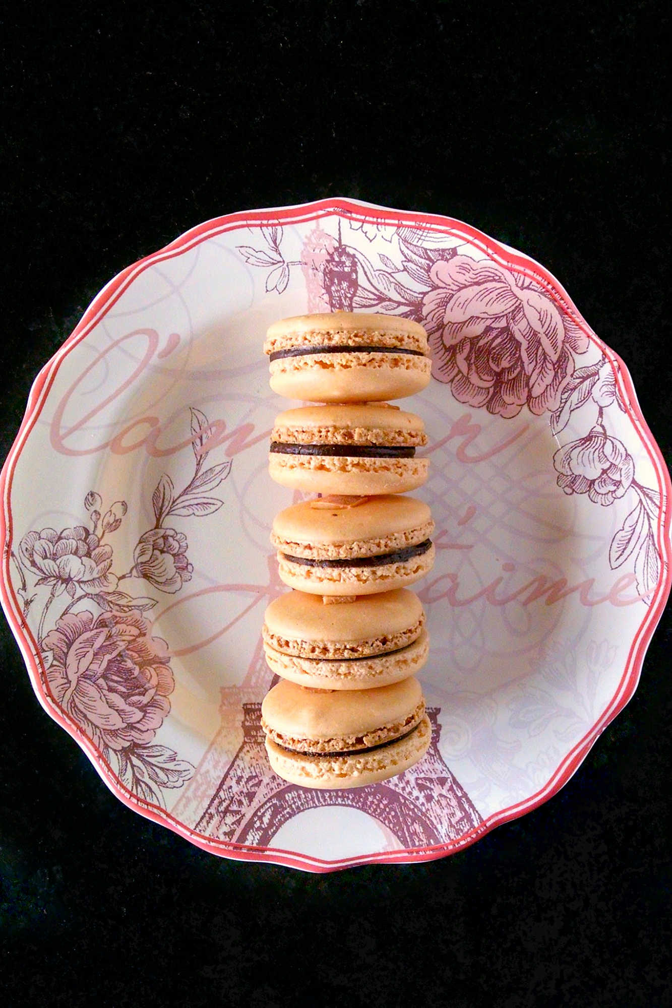 Satisfy your sweet tooth with a twist! Try these German Chocolate Cake Macarons for a unique and indulgent dessert experience. Made with coconut chips they have the sweet coconut flavor and chocolate deliciousness of the iconic cake. #GermanChocolateCakeMacaron #MacaronObsession #SatisfyYourSweetTooth #FoodieFridays #DessertHeaven