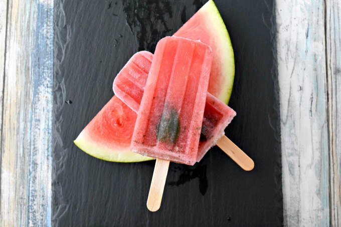 Summer sweet watermelon and mint are blended with rum in these scrumptious poptails! Watermelon Mojito Popsicles are just the thing to cool you off this summer! Replace the rum with simple syrup for a virgin version.