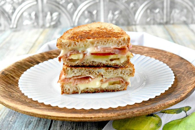 Apple Jamon Fontina Grilled Cheese are a sweet and savory sandwich everyone will devour!  The sweet apples, the salty jamon, and the creamy Fontina all come together in this decadently delicious grilled cheese sandwich.  They're easily grilled up on the Swiss Diamond, two burner griddle.   #AppleWeek