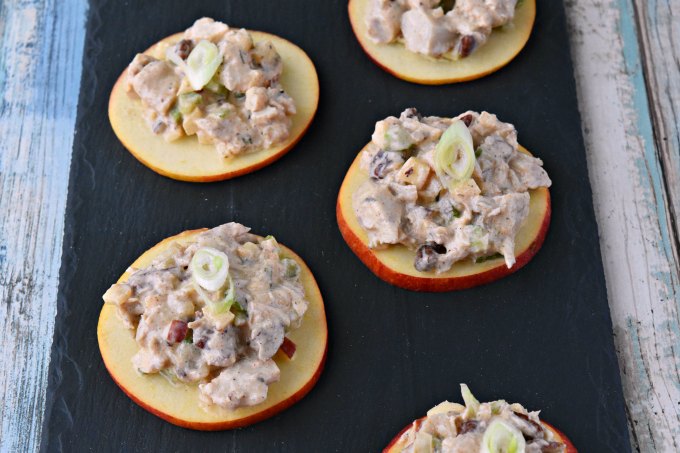 Savory and sweet chicken salad sits on top of apple slices for a delicious and quick appetizer.  Chicken Salad Apple Bites are a perfect afternoon snack, easy appetizer, or quick nibble before dinner.