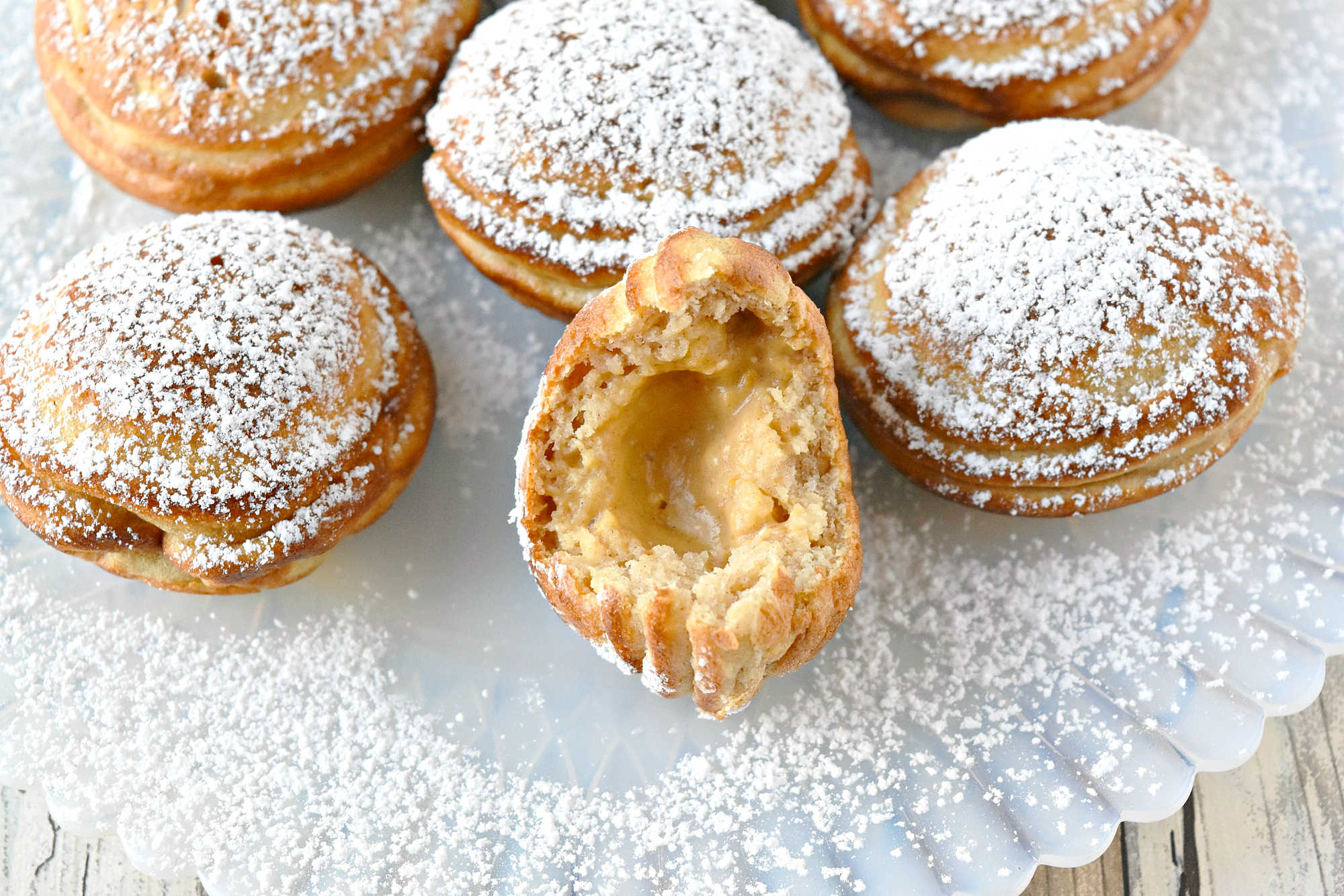 Say goodbye to boring breakfasts and hello to these Pumpkin Cheesecake Ebelskivers! Perfectly fluffy, filled with creamy pumpkin cheesecake, and finished with a dusting of powdered sugar. Your mornings just got a whole lot better. #PumpkinCheesecakeEbelskiver #FallTreats #PumpkinSpice #CulinaryDelights #FoodieFaves #PumpkinCheesecake #Ebelskivers #FallTreats #FestiveFlavors #HolidayBaking