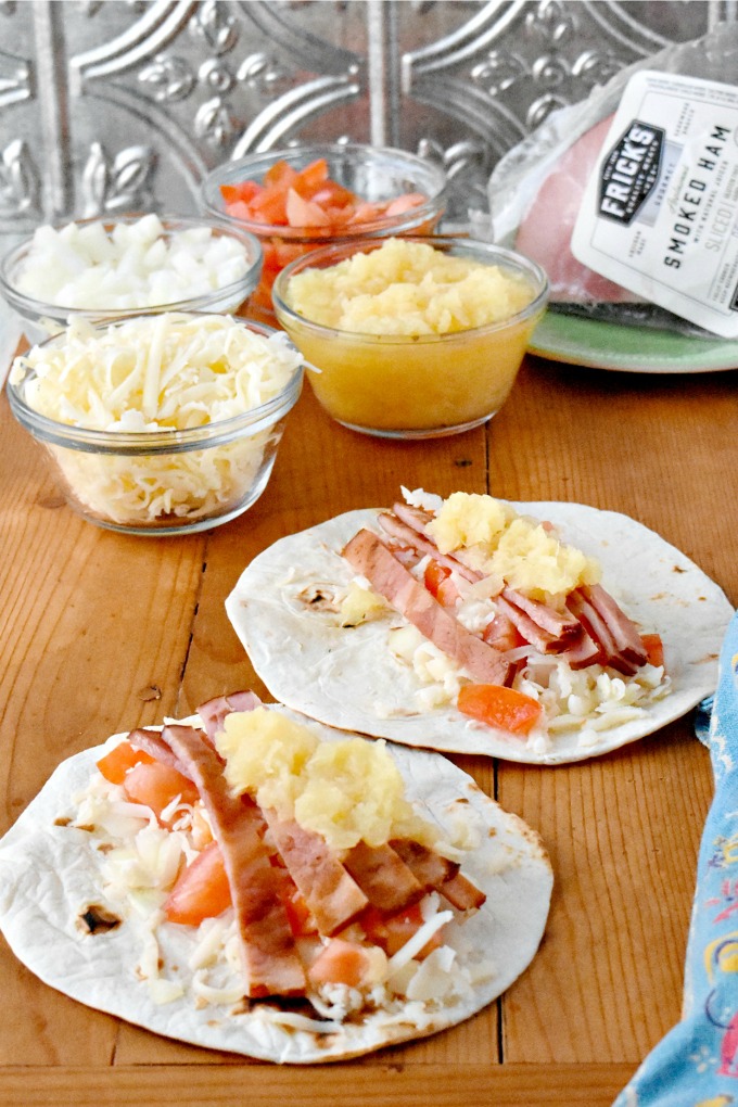 It takes longer to chop the toppings than it does to grill the ham.  That's why you and your family will love these Grilled Ham Hawaiian Tacos.  They're perfect for busy weeknights and fun for the family! #fricks #smokedmeats #itsfrickingood