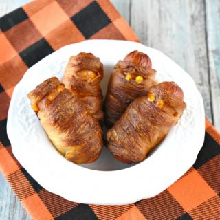 A package of hot dogs and a roll of pizza dough and you have a fun and delicious appetizer for your party or for your family.  Mini Mummy Dogs are easy to prepare and have a crispy outside from the baking soda bath. #HalloweenRecipes