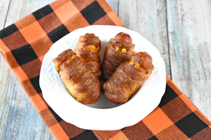 A package of hot dogs and a roll of pizza dough and you have a fun and delicious appetizer for your party or for your family.  Mini Mummy Dogs are easy to prepare and have a crispy outside from the baking soda bath. #HalloweenRecipes