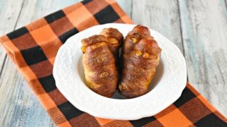A package of hot dogs and a roll of pizza dough and you have a fun and delicious appetizer for your party or for your family.  Mini Mummy Dogs are easy to prepare and have a crispy outside from the baking soda bath. #HalloweenRecipes