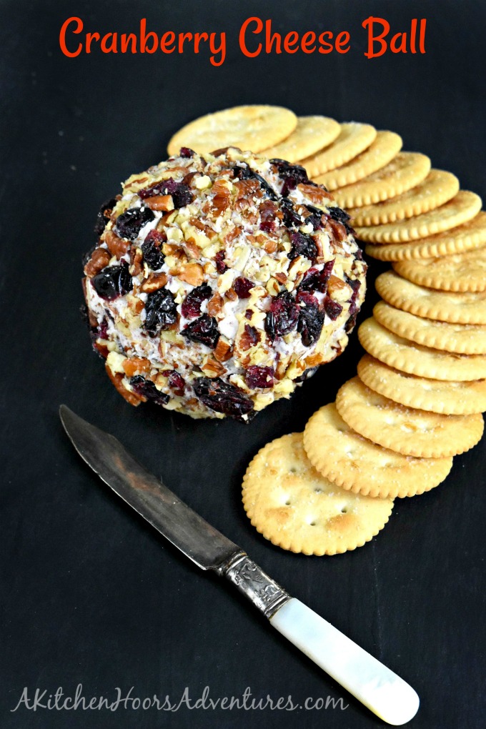 Cranberry Cheese Ball has a simple name, but not simple flavors.  Dried cranberries, rosemary, Menorca Spanish cheese, and cream cheese all come together for a delicious cheese ball rolled in roasted pecans and dried cranberries.  It’s the perfect appetizer for the holidays.