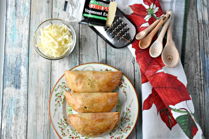 Dad always had sharp cheddar cheese with his apple pie.  I added Cabot Vermont sharp cheddar to the crust of these Apple Cheddar Hand Pies.  Not only do the smell amazing while baking, but taste scrumptious warm from the oven. #ChristmasSweetsWeek