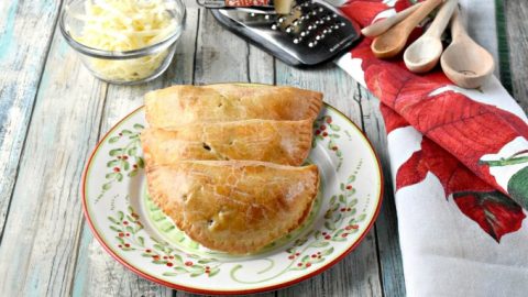 Dad always had sharp cheddar cheese with his apple pie.  I added Cabot Vermont sharp cheddar to the crust of these Apple Cheddar Hand Pies.  Not only do the smell amazing while baking, but taste scrumptious warm from the oven. #ChristmasSweetsWeek