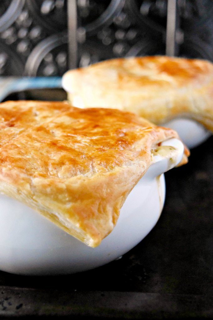 This Skillet Chicken Pot Pie tastes like it's been simmering all day, but it hasn't.  With a deliciously crispy puff pastry topping, your family is going to love these individually sized pot pies!
