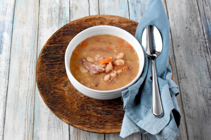 Instant Pot Ham and Bean Soup is a family favorite budget friendly recipe. Using leftover ham hock from New Year’s (or Easter if it’s vacuum sealed) an inexpensive bag of Navy beans, and you’ve got a delicious and hearty meal for your family. #OurFamilyTable