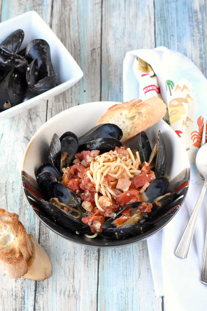 Tender mussels swim in a white wine tomato broth with garlic, shallots, proscuitto, and herbs.  Perfect for date night or a dinner party, Spicy Mussels Provençal are similar to a bouillabaisse style dish with less broth and a little more spice.  Oh, and pasta.  