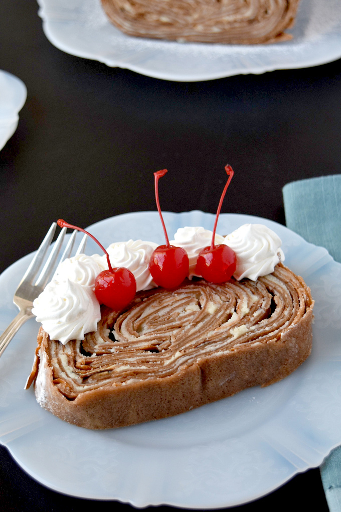 Take your traditional crepe cake and turn it on its side! Chocolate Crepe Cake Roll is a fun and different twist on both a cake roll and a crepe cake. #SpringSweetsWeek