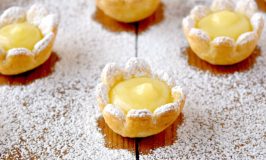 These dainty little flowers are super easy to make. Even the curd is easy because it’s made in the microwave! Lemon Daisy Tartlets are super cute and packed with sweet tart flavor of fresh lemon curd. They’re perfect for spring time menus! #SpringSweetsWeek