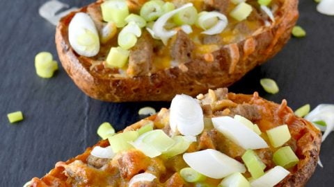 Breakfast Potato Skins have eggs nestled into baked potatoes skins topped with sausage and cheese.  They are easy to make ahead and a delicious twist on the classic appetizer! #BrunchWeek