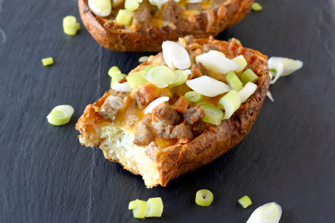 Breakfast Potato Skins have eggs nestled into baked potatoes skins topped with sausage and cheese.  They are easy to make ahead and a delicious twist on the classic appetizer! #BrunchWeek