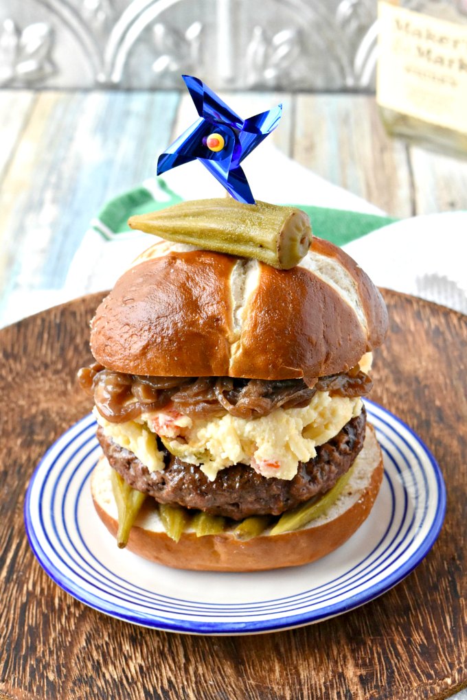 Kentucky Burger with Bourbon Onions and Pimento Beer Cheese is an homage to my family and childhood memories.  From the pimento cheese combined with beer cheese to the bourbon onions and pickled okra topping everything on this burger reminds me of home. #BurgerMonth