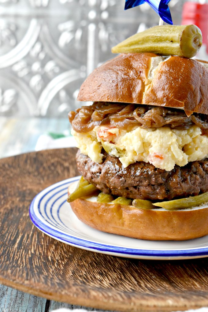 Kentucky Burger with Bourbon Onions and Pimento Beer Cheese is an homage to my family and childhood memories.  From the pimento cheese combined with beer cheese to the bourbon onions and pickled okra topping everything on this burger reminds me of home.