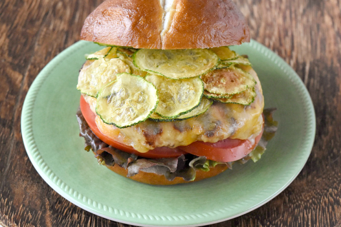 Apple Cheddar Chicken Burgers have apples, onions, ancho chile powder, and buttermilk soaked breadcrumbs. As if that wasn't enough, they're flecked with Cabot extremely sharp Cheddar cheese and topped with zucchini chips, too.