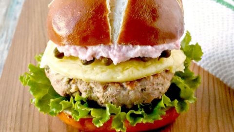 Chicken Piccata Burgers have a hint of lemon, fresh spinach, grated onion, and capers.  Yes, capers are in the burger.  It’s topped with a delicious roasted radish aioli. #piccatalover #burgertime #burgerporn #chickenburger