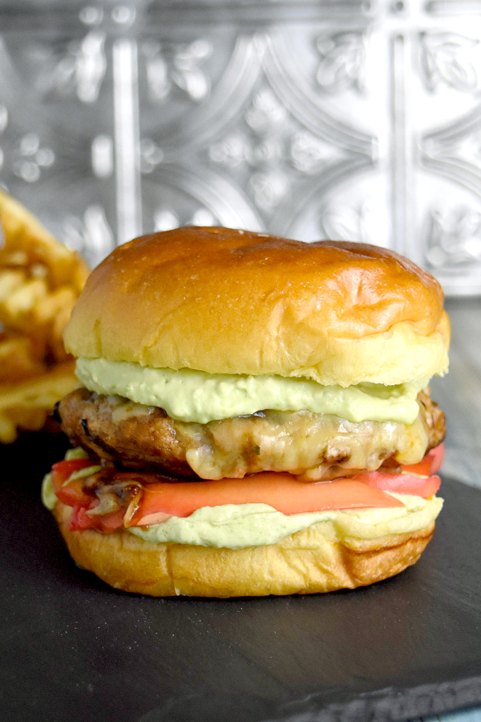What do you make with pork, avocado, mango, and red hots? Pork Taco Burgers with Red Hot Mango Pickles topped with avocado crema. #BurgerMonth #BurgerMonth2019