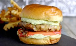 What do you make with pork, avocado, mango, and red hots? Pork Taco Burgers with Red Hot Mango Pickles topped with avocado crema. #BurgerMonth #BurgerMonth2019