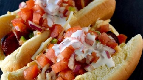 Air Fryer Bacon Wrapped Hot Dogs are simple to make and elevated with pico de gallo and crema toppings. The smoky and salty bacon complements the crisp and cool pico and rich crema. #OurFamilyTable