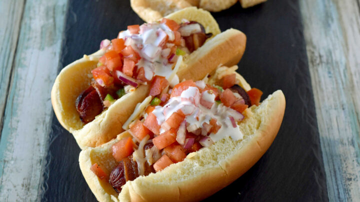 Air Fryer Bacon Wrapped Hot Dogs are simple to make and elevated with pico de gallo and crema toppings. The smoky and salty bacon complements the crisp and cool pico and rich crema. #OurFamilyTable