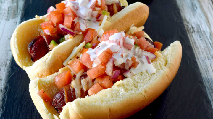 Air Fryer Bacon Wrapped Hot Dogs are simple to make and elevated with pico de gallo and crema toppings. The smoky and salty bacon complements the crisp and cool pico and rich crema. #OurFamilyTable
