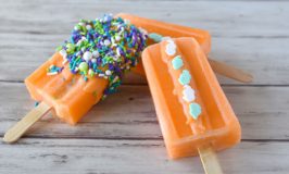 Orange Julius Popsicles are the color of a goldfish, but taste orangey and creamy. To play off the color, they’re decorated with Sweets & Treats Boutique seahorse quinn sprinkles and sea splash sprinkles mix. #SummerDessertWeek