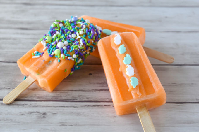 Orange Julius Popsicles are the color of a goldfish, but taste orangey and creamy. To play off the color, they’re decorated with Sweets & Treats Boutique seahorse quin sprinkles and sea splash sprinkles mix. #SummerDessertWeek