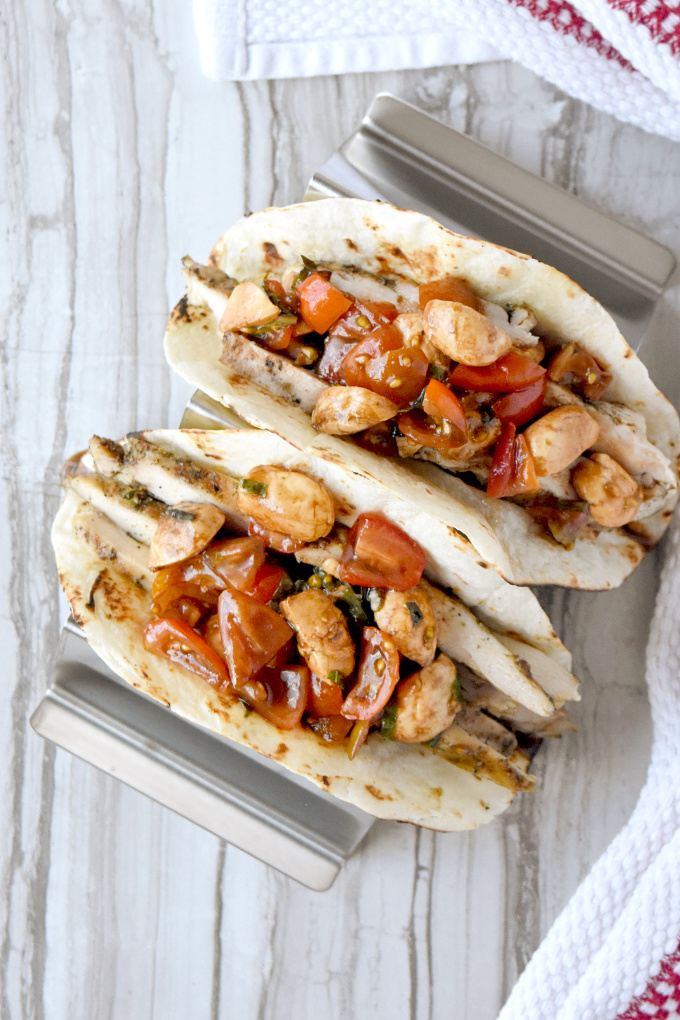 Market fresh tomatoes and basil make up the topping for Bruschetta Chicken Tacos.  The Tuscan seasoned thighs and marinated Mozzarella add layers of delicious flavor you'll love! #FarmerksMarketWeek