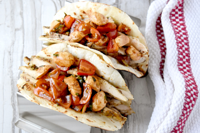Market fresh tomatoes and basil make up the topping for Bruschetta Chicken Tacos. The Tuscan seasoned thighs and marinated Mozzarella add layers of delicious flavor you'll love! #FarmerksMarketWeek