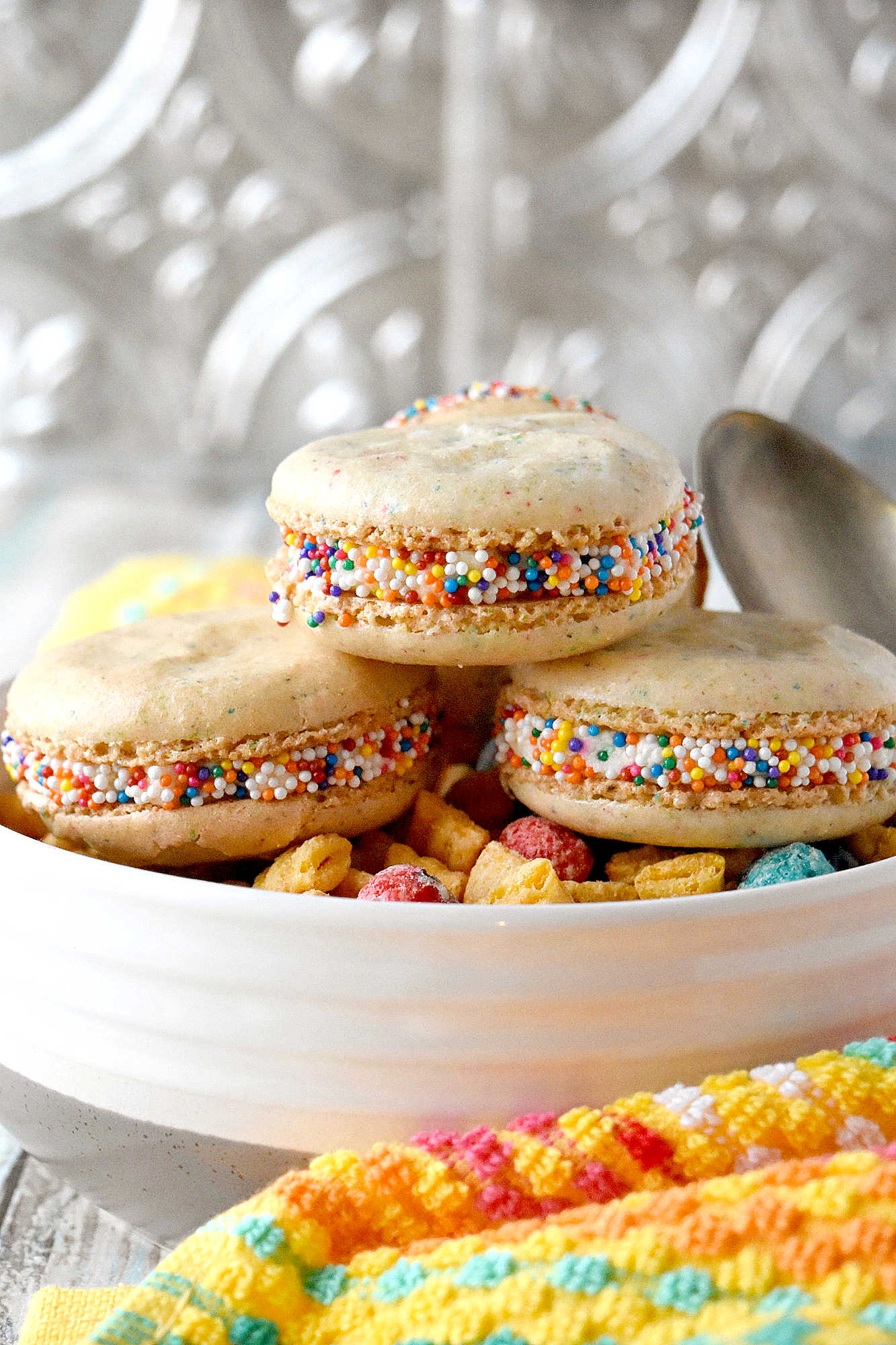 Cereal Milk Macaron taste like your favorite fruit cereal.  There's cereal in the shells and cereal milk in the buttercream.   #BacktoSchoolTreats