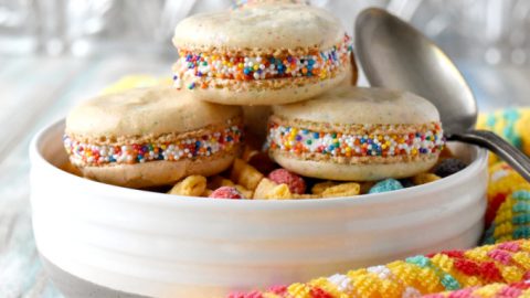 Cereal Milk Macaron taste like your favorite fruit cereal.  There's cereal in the shells and cereal milk in the buttercream.   #BacktoSchoolTreats