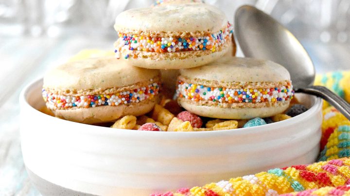 Cereal Milk Macaron taste like your favorite fruit cereal.  There's cereal in the shells and cereal milk in the buttercream.   #BacktoSchoolTreats