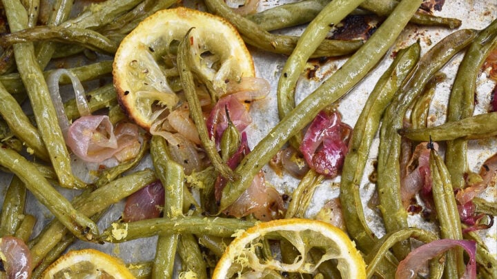 It doesn’t take much to make fresh summer green beans taste absolutely amazing. Roasting them is definitely the way to go. Topping them with a thinly sliced lemon while they are roasting and the zest and juice of yet another lemon after they are roasted helps to add lots of bright, tangy, and delicious lemony flavor.