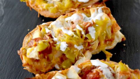 Rotisserie chicken, salsa, cheese, and a loaf of French bread make a quick and easy Chicken Taco French Bread Pizza.  It's on the table in under 30 for a fast and family friendly dinner. #OurFamilyTable