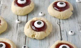 Turn a simple and easy thumprint cookie into Eyeball Thumbprint Cookies!  Filled with cherry jam and topped with large candy eyes for a fun Halloween treat. #HalloweenTreatsWeek