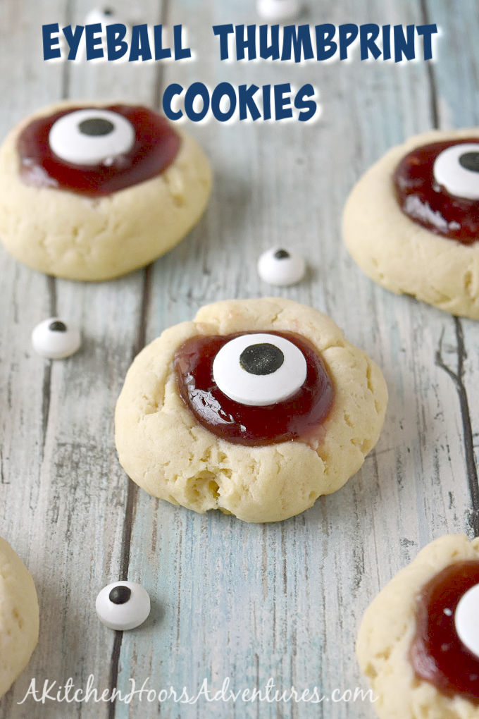 Turn a simple and easy thumbprint cookie into Eyeball Thumbprint Cookies!  Filled with cherry jam and topped with large candy eyes for a fun Halloween treat. #HalloweenTreatsWeek