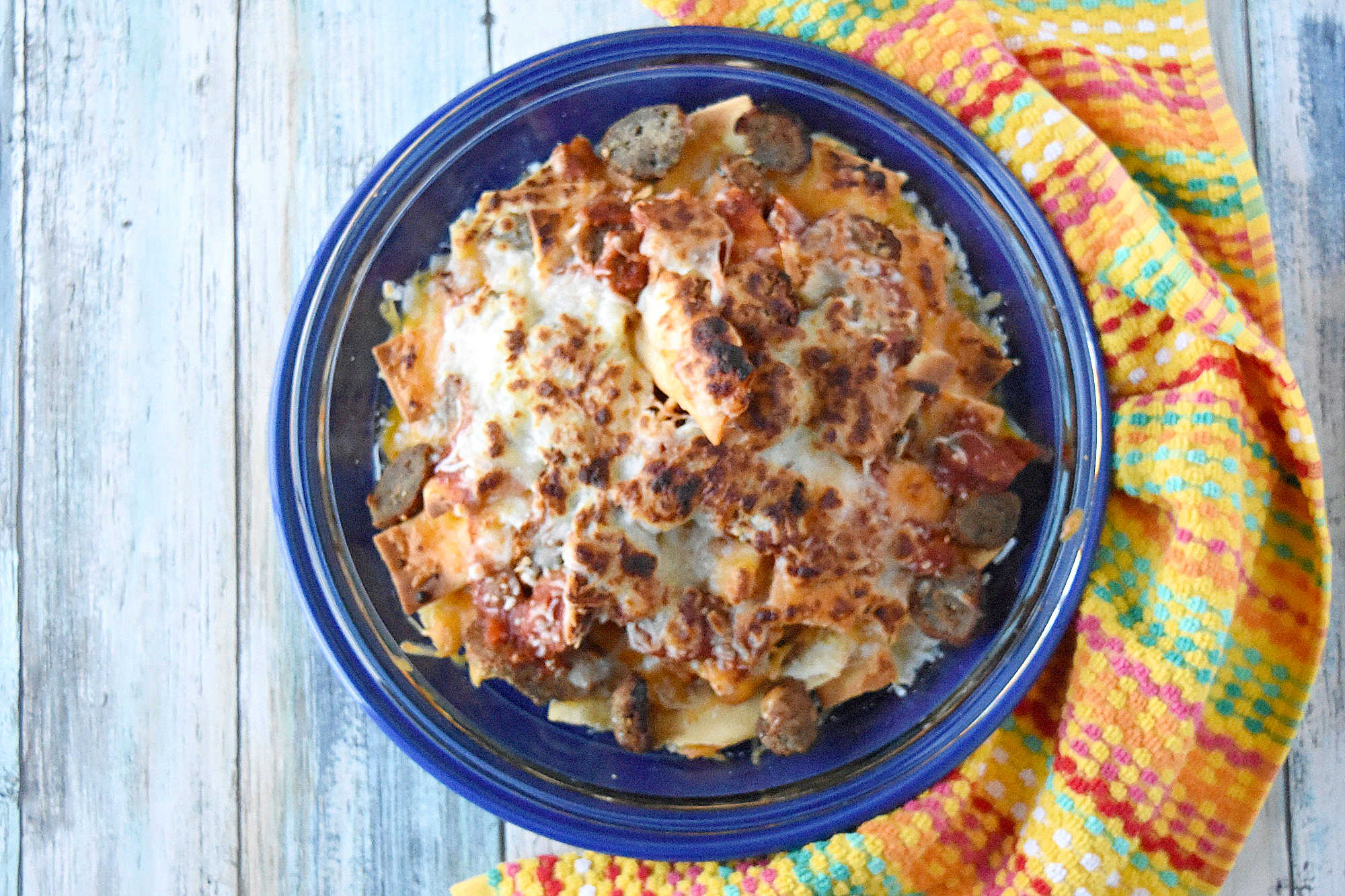 Italian Meatball Nachos are a delicious twist on your typical nachos.  These nachos are made super easy with frozen meatballs, jarred pizza sauce, and shredded mozzarella cheese. #OurFamilyTable