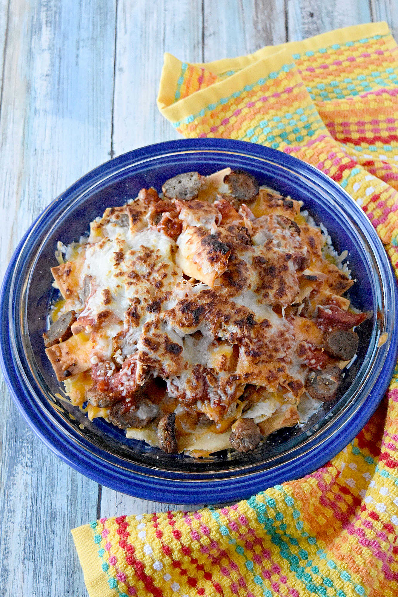Italian Meatball Nachos are a delicious twist on your typical nachos.ย These nachos are made super easy with frozen meatballs, jarred pizza sauce, and shredded mozzarella cheese. #OurFamilyTable
