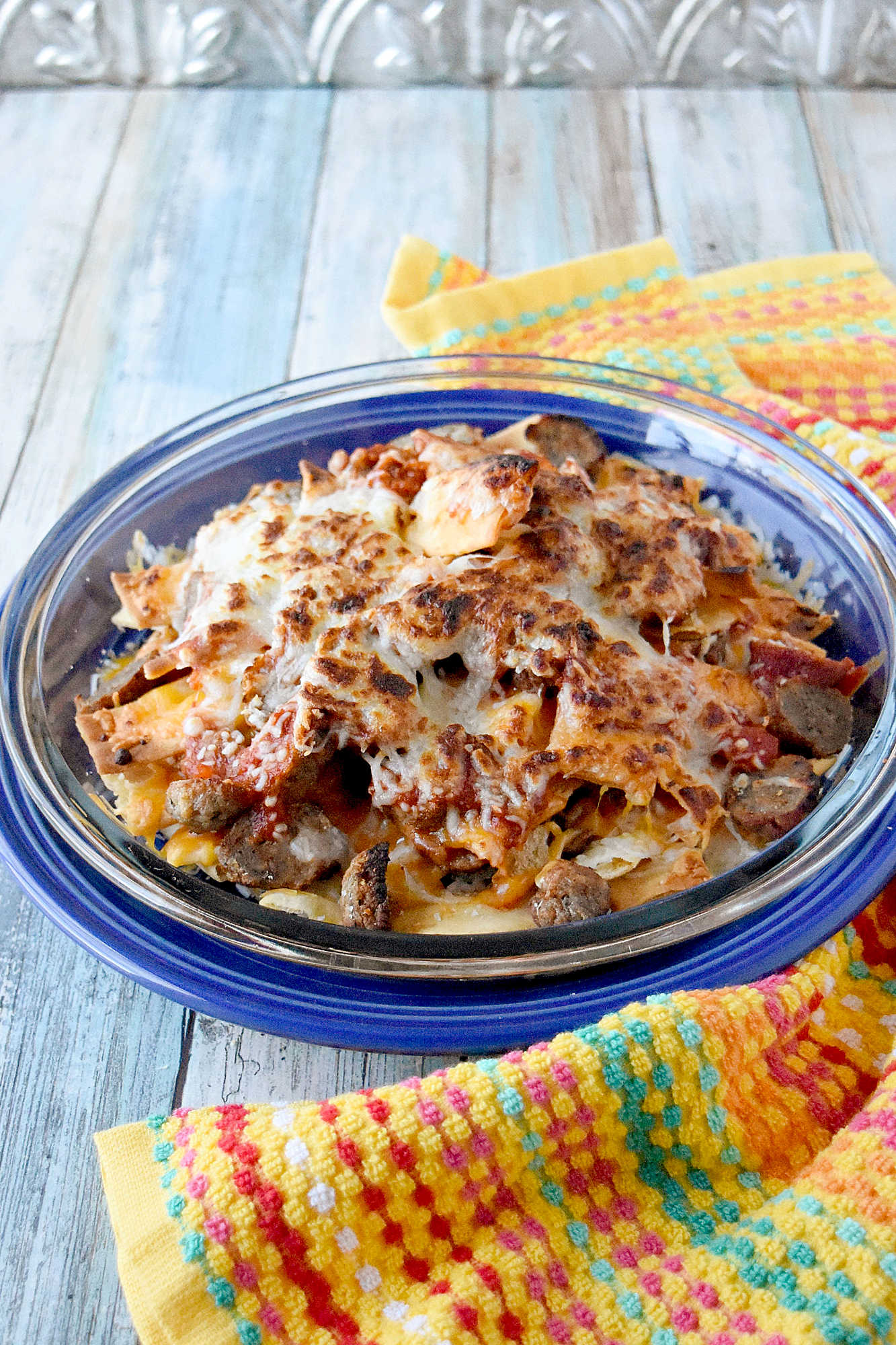 Italian Meatball Nachos are a delicious twist on your typical nachos.ย These nachos are made super easy with frozen meatballs, jarred pizza sauce, and shredded mozzarella cheese. #OurFamilyTable