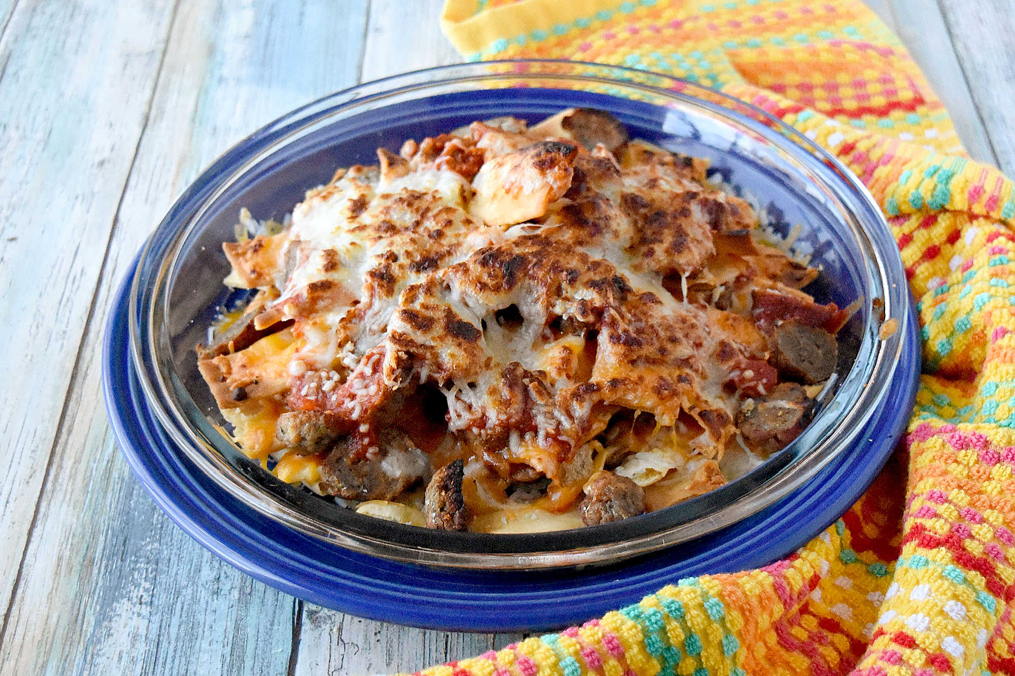 Italian Meatball Nachos are a delicious twist on your typical nachos.ย These nachos are made super easy with frozen meatballs, jarred pizza sauce, and shredded mozzarella cheese. #OurFamilyTable