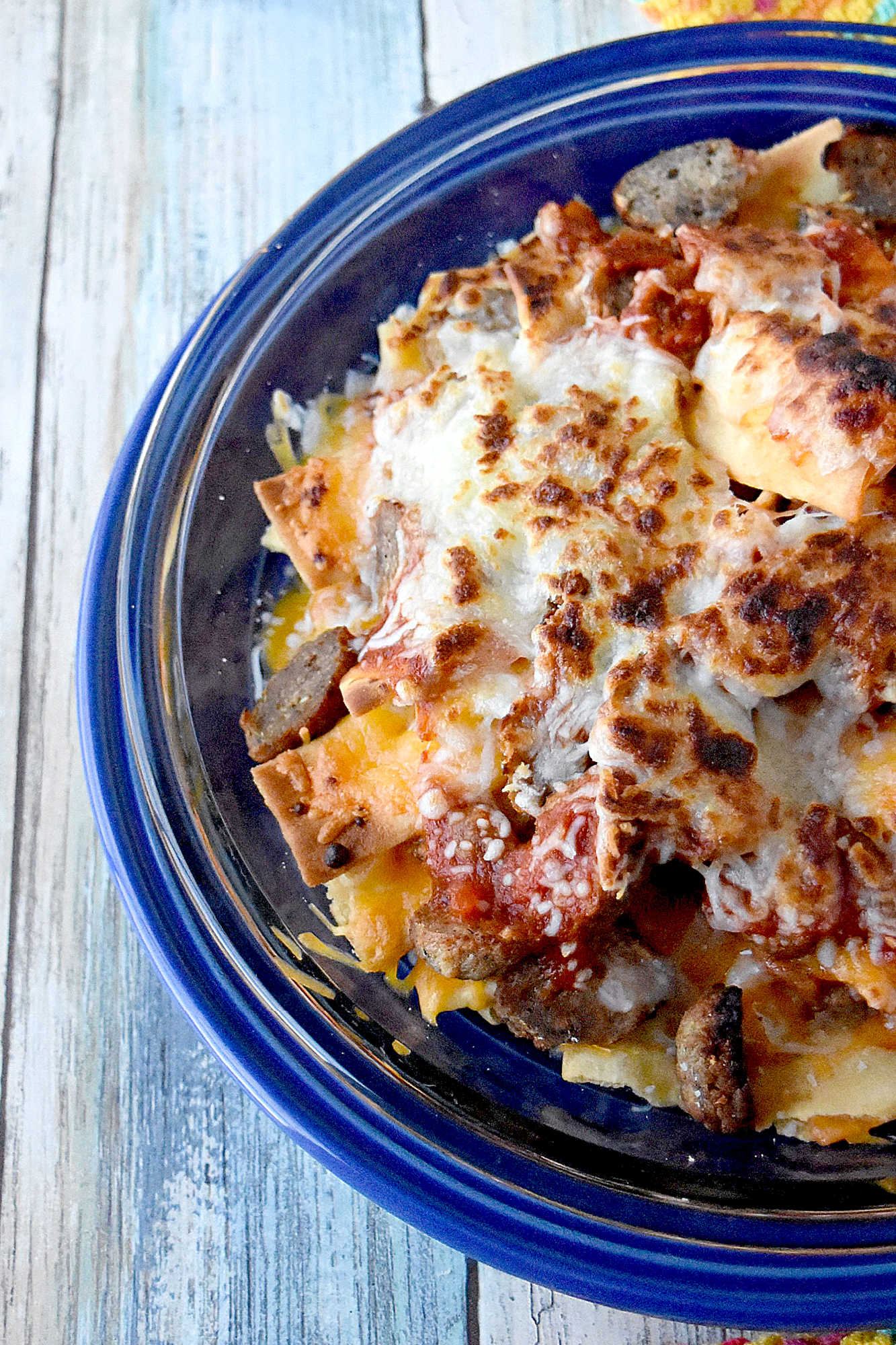 Italian Meatball Nachos are a delicious twist on your typical nachos.ย These nachos are made super easy with frozen meatballs, jarred pizza sauce, and shredded mozzarella cheese. #OurFamilyTable