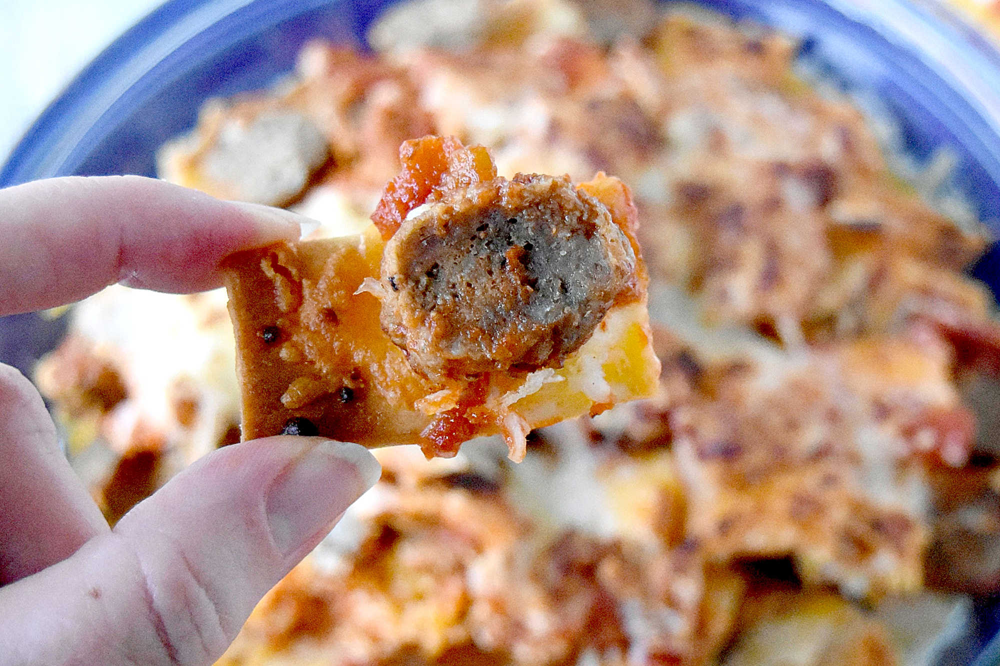 Italian Meatball Nachos are a delicious twist on your typical nachos.ย These nachos are made super easy with frozen meatballs, jarred pizza sauce, and shredded mozzarella cheese. #OurFamilyTable