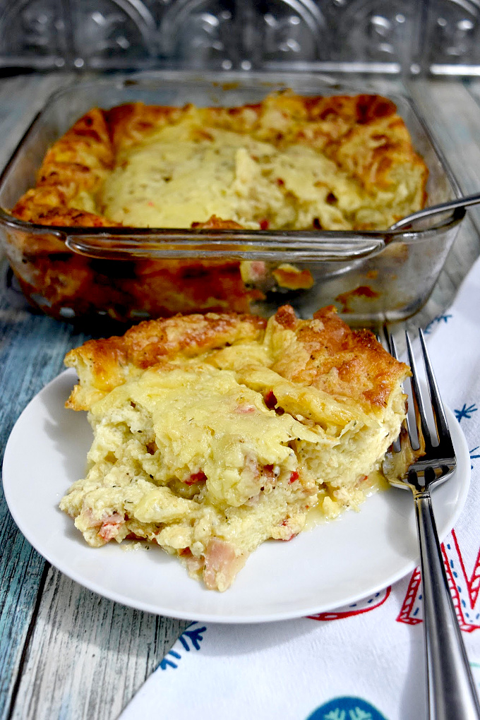 Leftover bread, turkey, cheese combined with eggs, cream and milk make a deliciously simple Overnight Breakfast Casserole.  It's perfect to pop in the oven while you open presents. #OurFamilyTable