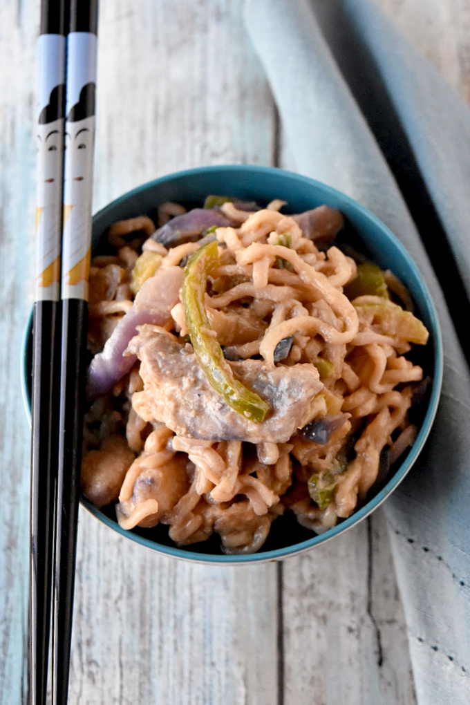 Instant ramen turns into a deliciously easy weeknight meal. Thai Peanut Chicken Ramen is packed with vegetables, peanut butter, and delicious Asian flavors. #OurFamilyTable
