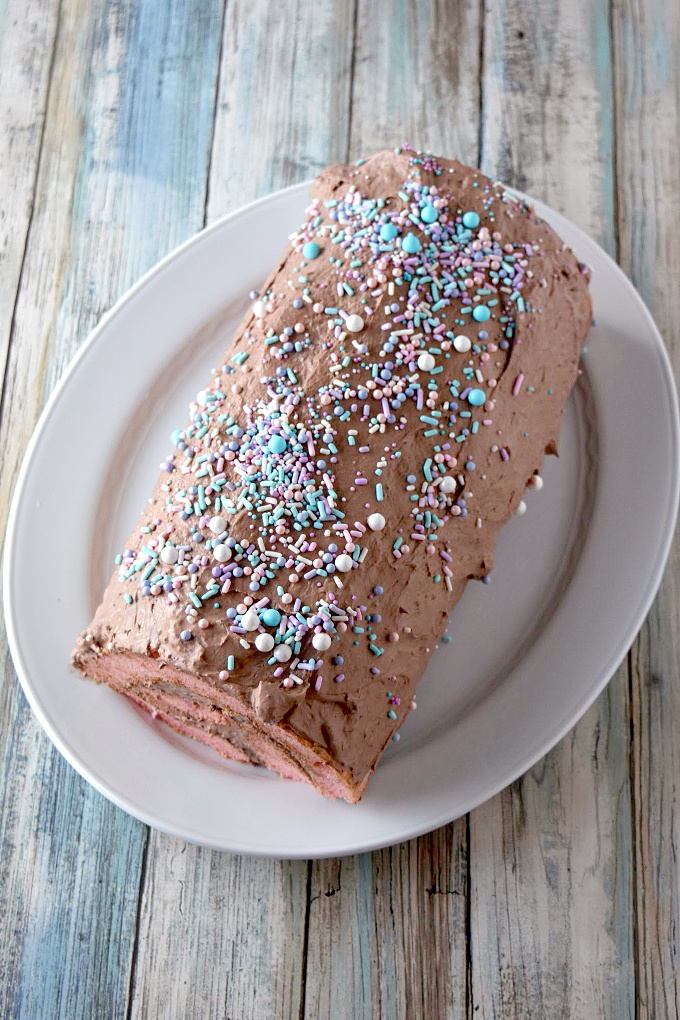 Easy chocolate mousse covers boxed strawberry cake in this Chocolate Covered Strawberry Cake Roll.  This is a simple and easy pantry recipe you can make with your kids.