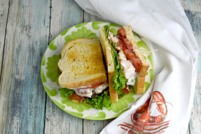 Lobster Roll BLT is a delicious mash up of both sandwiches! Broiled lobster is tossed with mayonnaise, lemon juice, and green onions and tops lettuce and tomato before being topped with bacon. It’s a deliciously smoky and sweet sandwich that is irresistible.