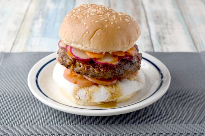 Spicy Bulgogi Burger is packed with garlic and ginger flavor, spicy Asian sauce, and topped with thinly sliced carrots and radishes.  It's a flavor and texture packed yum on a bun! #BurgerMonth
